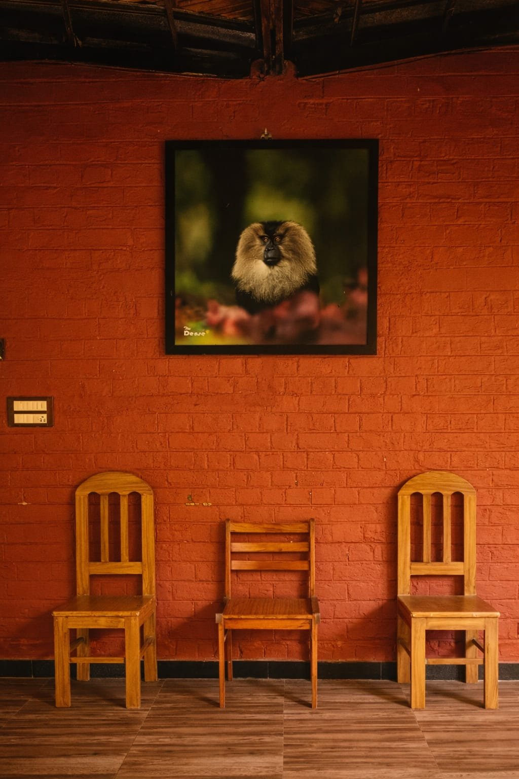 Red brick wall with wooden chairs